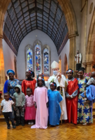 St Daniel Comboni - Archbishop with dancing girls.PNG
